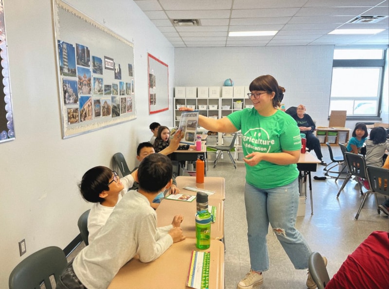 CALM volunteer high-fiving students