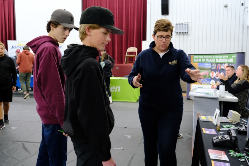 Students and exhibitors interacting at agriculture career fair