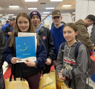 Group of students at Manitoba Ag Days Adventure smiling and looking at camera