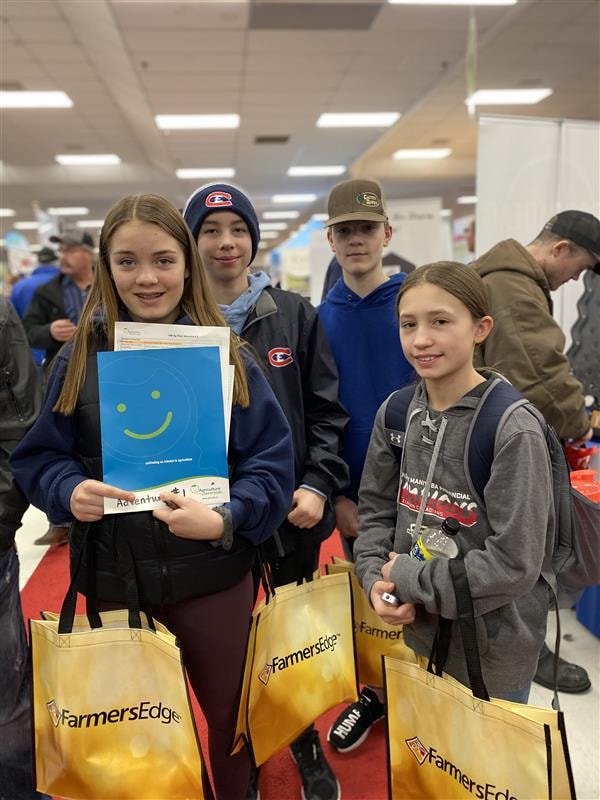 Group of students at Manitoba Ag Days Adventure smiling and looking at camera